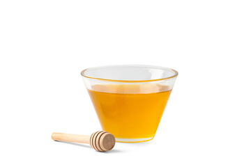 Honey in a bowl with a wooden dipper on a white isolated background.