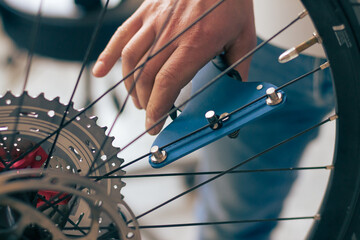 Close up on bike and bicycle wheels repair tools, background is blurred.