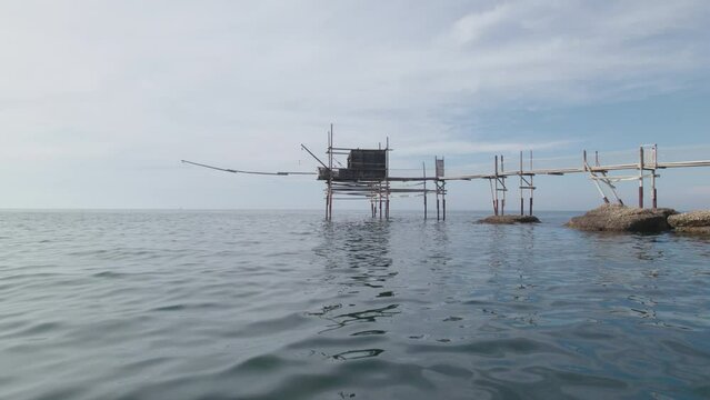Impressive fishing platforms on stilts on the trabocchi coast of Abruzzo, Punta Aderci, Italy 4k drone