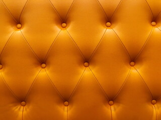 Vintage orange leather Sofa Button for textured background