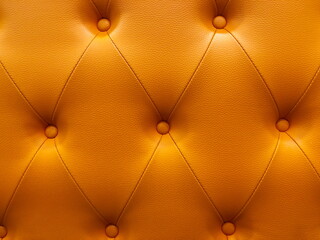 Vintage orange leather Sofa Button for textured background