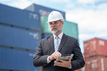 The warehouse manager or business man are using tablet view analytics warehouse information