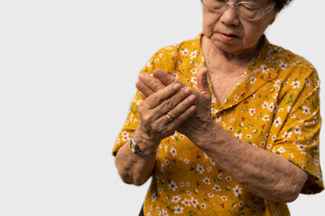 Elderly Asian woman patients suffer from numbing pain in hands from rheumatoid arthritis. Senior...