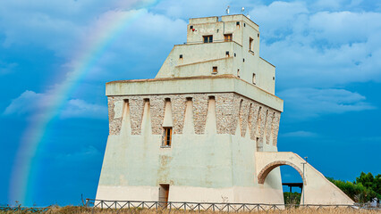 Coastal defense tower on the Adriatic coast, Gargano - Torre Mileto, Puglia. ITALY. A rainbow was produced by GENERATIVE AI