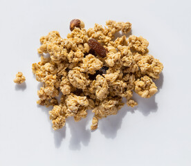 a bunch of granola on a gray background with hard shadows