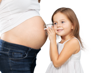 Kid girl listening with can pregnant mother's stomach