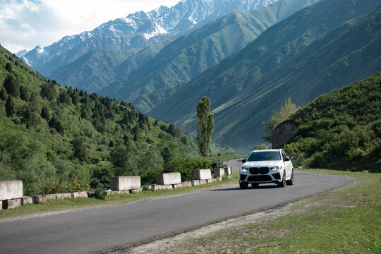 Bishkek, Kyrgyzstan - MAY 22, 2023: Road in Kyrgyzstan mountains with BMW X6 car
