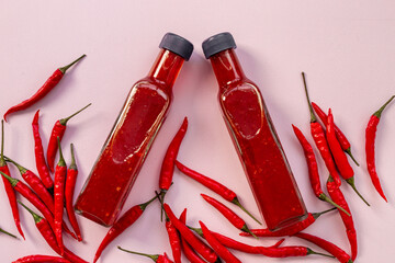 Tabasco hot pepper sauce with red chili pepper, flat lay