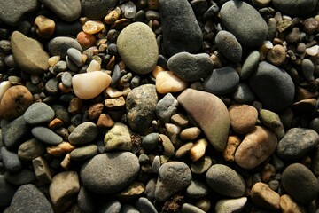 Stones of different sizes on the beach. Background texture.