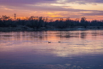 Naklejka premium Sunset over Vistula River seen from a bank in Tarchomin area of Warsaw, Poland