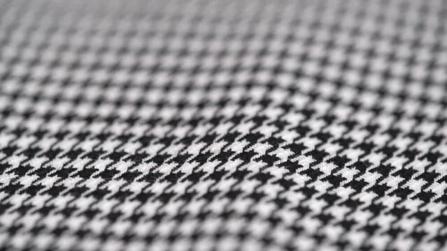 rotation of the texture of tweed fabric houndstooth, classic woolen pattern close up. black and white houndstooth pattern. woven textile background.