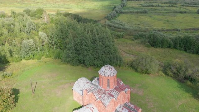 The old Orthodox Church of the Savior on Kovalev on the outskirts of Veliky Novgorod. The view from the drone on a sunny day.