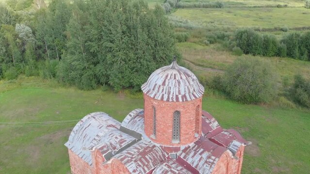 The old Orthodox Church of the Savior on Kovalev on the outskirts of Veliky Novgorod. The view from the drone on a sunny day.