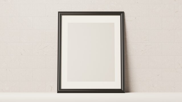 Blank black picture frame on a beige tiled wall