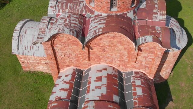 The old Orthodox Church of the Savior on Kovalev on the outskirts of Veliky Novgorod. The view from the drone on a sunny day.