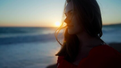 Side view smiling woman in golden sunlight at twilight on Cyprus. Positive beautiful happy Caucasian tourist at sunset in dusk on Mediterranean sea coast - Powered by Adobe