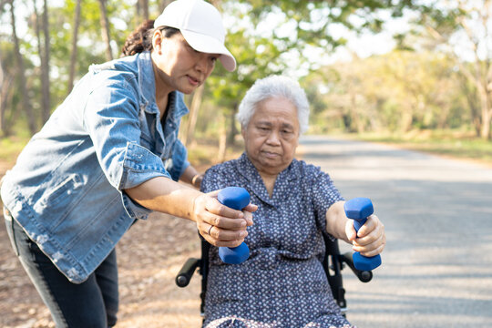 Asian elderly woman exercise with dumbbell in park, healthy strong medical concept.