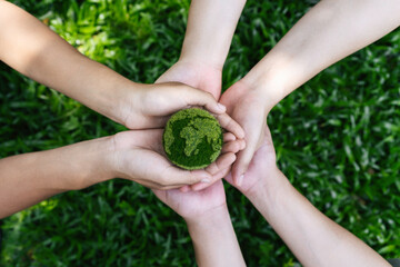 Naklejka na ściany i meble Environment Earth Day In the top view the hands holding green earth. care, saving and energy are renewable and the environment is sustainable. Save Earth. Concept of the Environment World Earth Day.