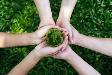 Environment Earth Day In the top view the hands holding green earth. care, saving and energy are...