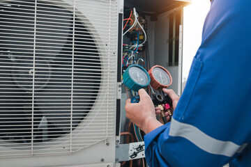 Technician is checking air conditioner,measuring equipment for filling air conditioners.