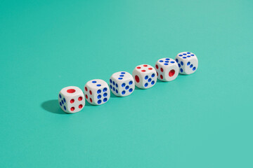 Dice arranged in a row on green background