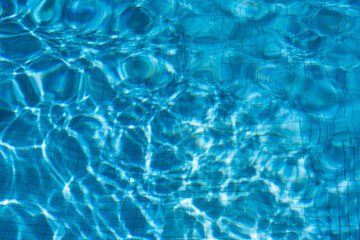 Fototapeta na wymiar The texture of the water in the summer pool close-up