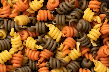 Uncooked Trottole tricolore pasta close up full frame as background