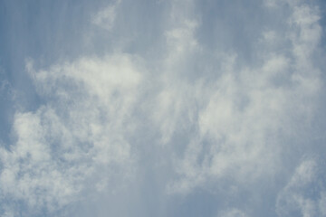 Wind braking clouds on a blue sky