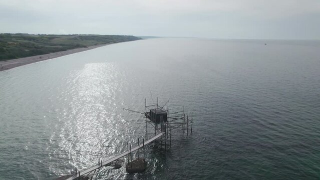 Impressive fishing platforms on stilts on the trabocchi coast of Abruzzo, Punta Aderci, Italy 4k drone