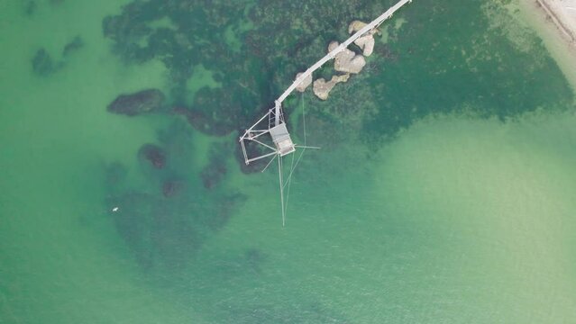 Impressive fishing platforms on stilts on the trabocchi coast of Abruzzo, Punta Aderci, Italy 4k drone