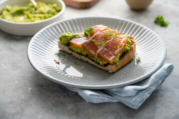 Toasts with salmon, guacamole avocado and herbs. Healthy food