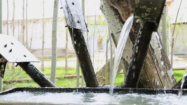 water wheel rotates and draws water slowly