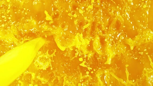 Super Slow Motion of Pouring Orange Juice Into Glass, Top Down angle. Filmed on high speed cinema camera Phantom VEO 4K, 1000 fps.