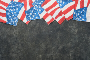 Obraz premium 4th of July background. USA paper fans, Red, blue, white stars, balloons, gold confetti on gray dark concrete background. Happy Labor, Independence or Presidents Day. American flag colors. Top view.