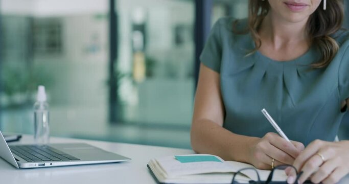 Business woman writing notes with laptop in office for planning schedule, email administration or information. Female employee, notebook planner and computer technology for online research in company