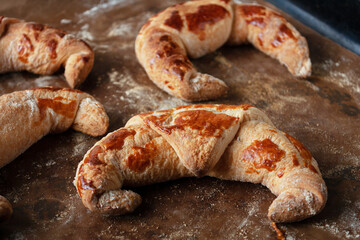 ruddy croissants lie on baking paper