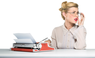 Beautiful young woman typing notes with a typewriter