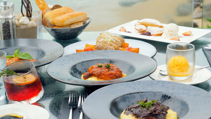 Enjoy a romantic dinner on beach with breathtaking ocean views. Table is beautifully set at a seafront restaurant in Phuket, offering luxurious and memorable dining experience.