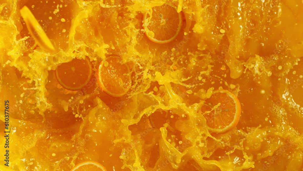 Fototapete Orange slices splashing into juice, macro shot. Macro background. Filmed on a high-speed cinema camera at 1000 fps.
