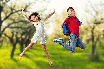 Happy young Children Jumping on forest background