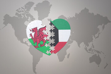 puzzle heart with the national flag of kuwait and wales on a world map background.Concept.