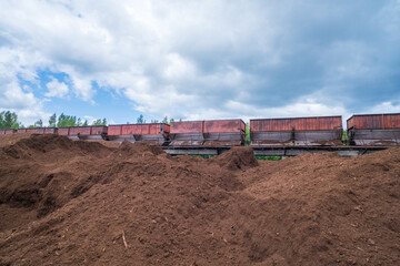 peat transport wagons at the loading point. Raised platform for loading and unloading peat