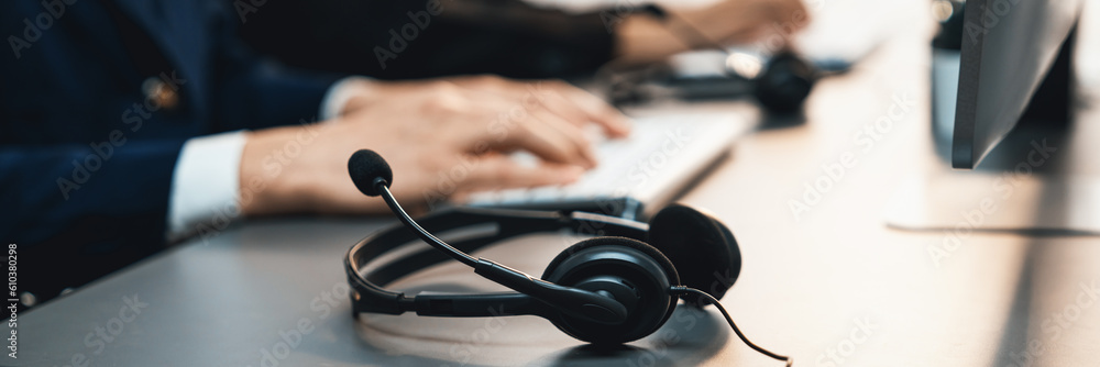 Aufkleber panorama focus headset on call center workspace desk with blur background of operator team or telesa