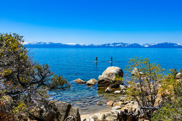 Stand Up Paddleboarders along the East Shore of Lake Tahoe near Sand Harbor on a clear Spring Day