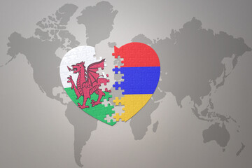 puzzle heart with the national flag of armenia and wales on a world map background.Concept.