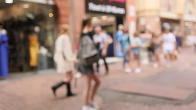 Street in with defocussed people shopping