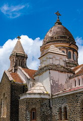 Fototapeta premium Weathered and colorful dome or cupola of “Sacré-Coeur de Balata“, church (1915) near Fort-de-France, capital of Martinique island, . Christian monument and tourist attraction in tropical landscape.