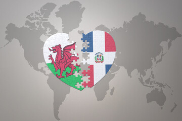 puzzle heart with the national flag of dominican republic and wales on a world map background.Concept.