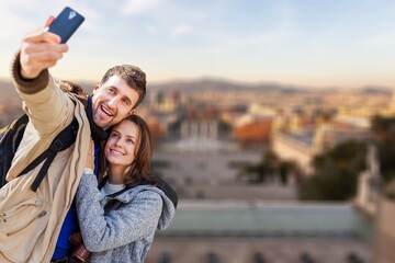 Young happy couple traveler using phone for taking selfie