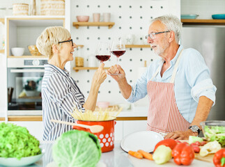 love kitchen senior woman man couple wine glass drink toast toasting retirement food  husband wife together